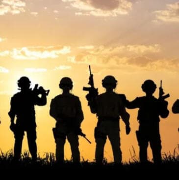 Silhouettes of soldiers at sunset.